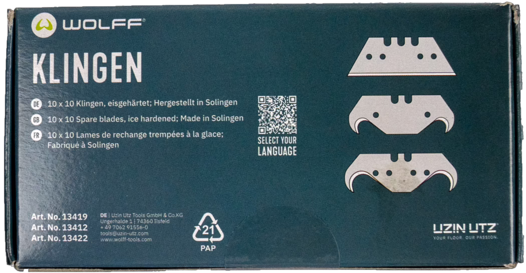 Dark teal-blue rectangular cardboard box of the WOLFF brand with a large white title 'KLINGEN' on the left and three stylized blade illustrations on the right showing different hook shapes. The package lists multilingual product information in German, English and French stating '10 x 10 spare blades, ice hardened; Made in Solingen' and features a small QR code with the text 'SELECT YOUR LANGUAGE'. Lower-left printing shows article numbers (Art. No. 13419, 13412, 13422) and manufacturer contact details for Uzin Utz. A recyclable 'PAP 21' symbol and the UZIN UTZ logo with the slogan 'YOUR FLOOR. OUR PASSION.' are visible. The box corners show minor wear and one blade illustration has slight discoloration; overall the packaging appears intact and ready for retail.